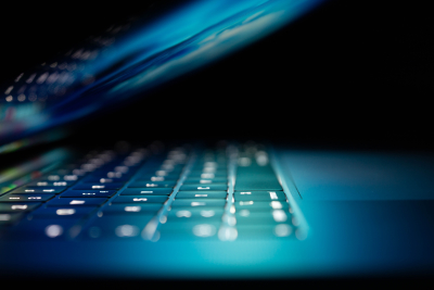 Stylized view of laptop keyboard illuminated by screen